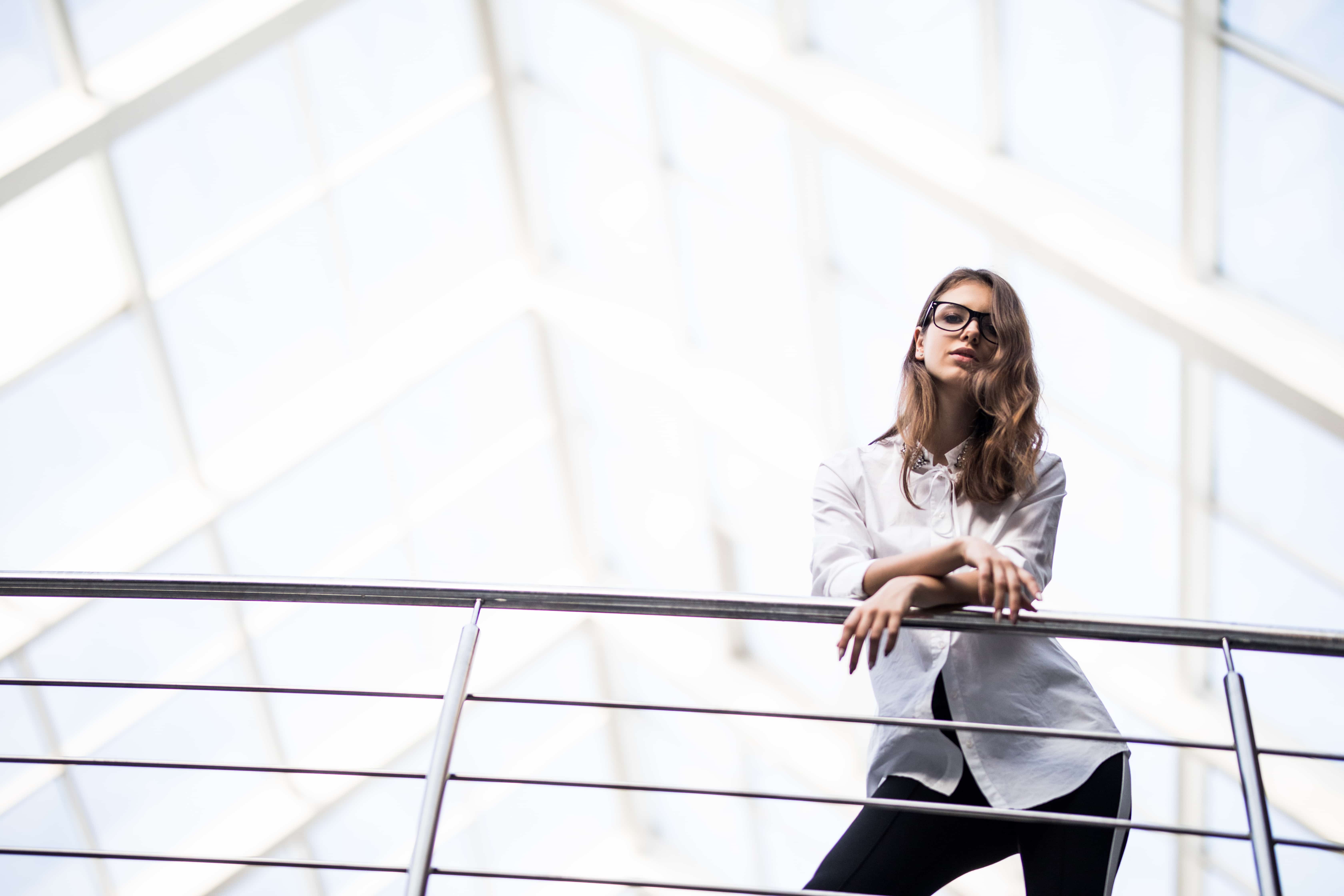 young-attractive-woman-modern-office-desk-working-with-laptop-thinking-about-something